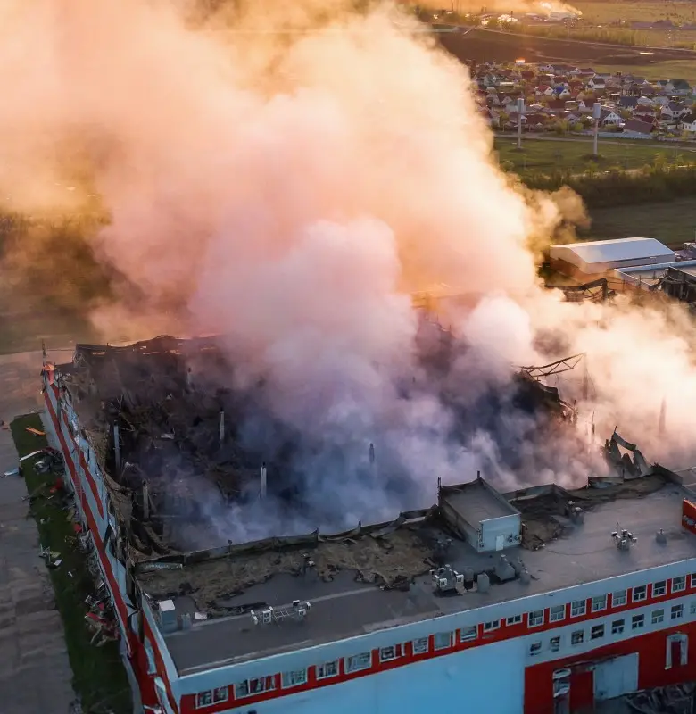 Emergency response scene at a smoke-filled industrial building
