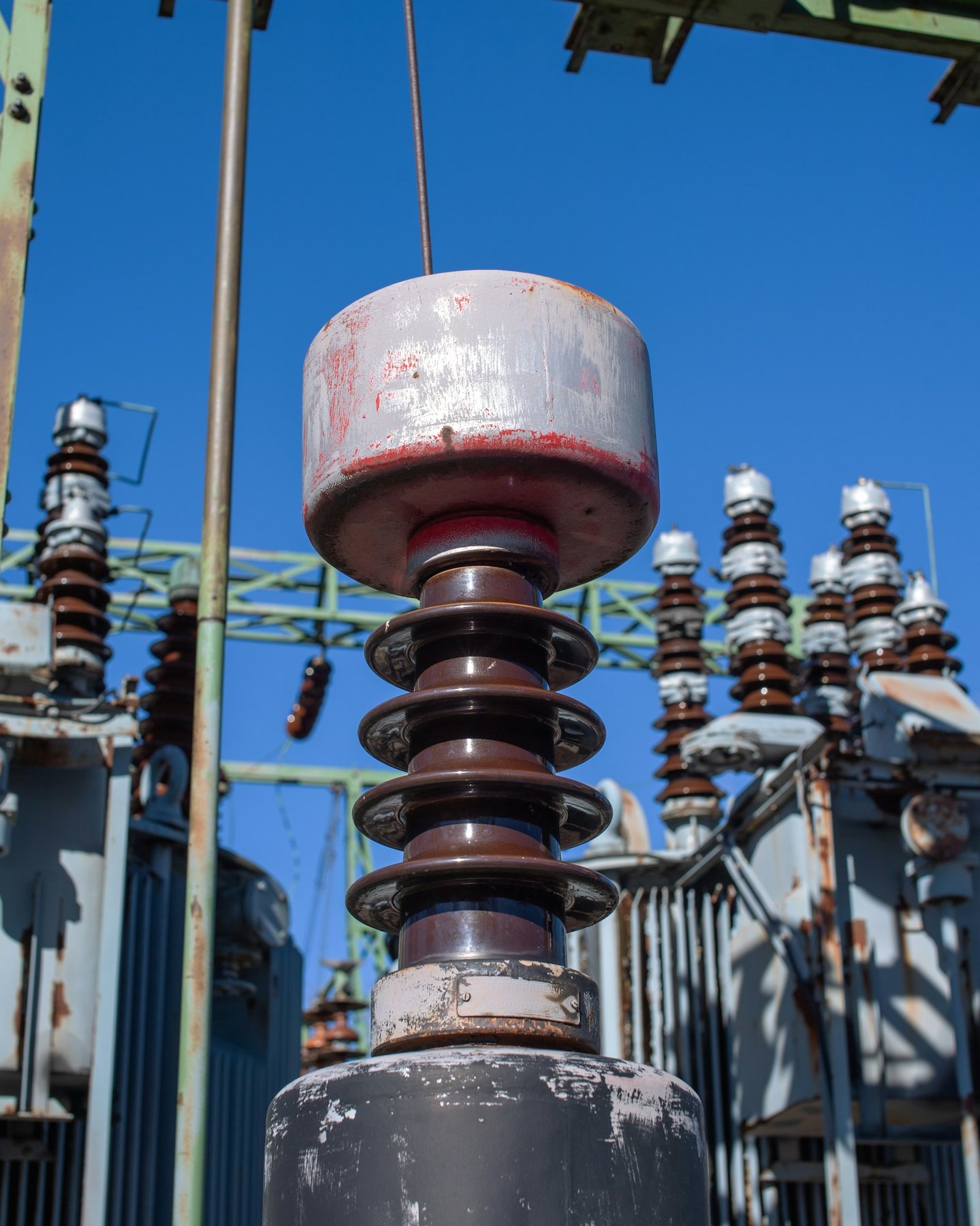 Close view of high-voltage electrical insulators and substation equipment